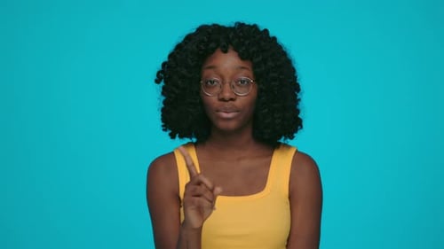 Young Adult Woman Giving Guidance on Cyan Background