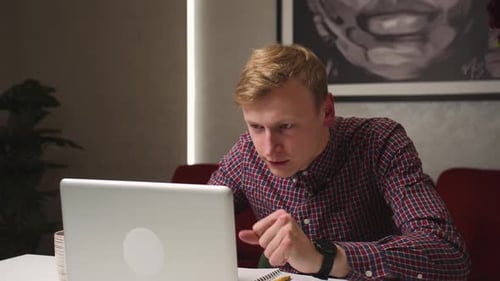 Man Celebrates Success At His Laptop