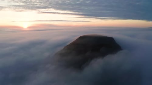 Aerial View of the Mountains in the Clouds at Sunset