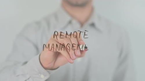 Hand Writes Remote Management on Clear Surface