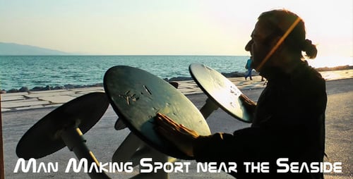 Adult Using Outdoor Exercise Equipment by Beach at Sunrise
