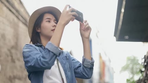 Young Woman Tourist Taking Pictures in the City