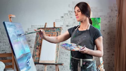 Smiling Beautiful Female Painter Enjoying Working at Art Studio Medium Shot
