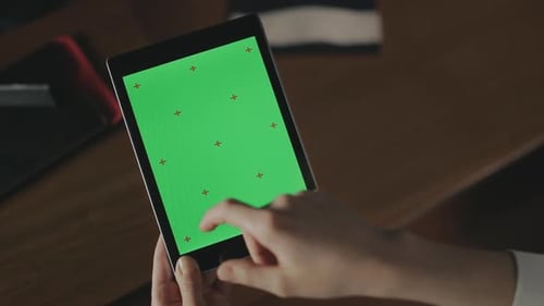 Female Hand Gesturing on Green Screen Tablet. Woman Swiping Finger Tablet Screen