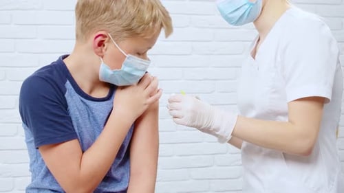 Child Receives an Injection From Healthcare Professional