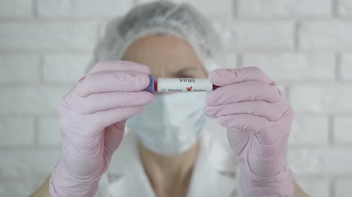 Virus Positive Blood Sample Held by Doctor