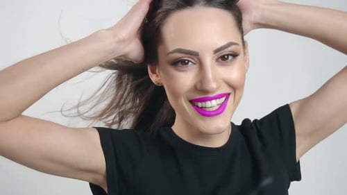 Beautiful Woman with Pink Lipstick Smiling in Studio