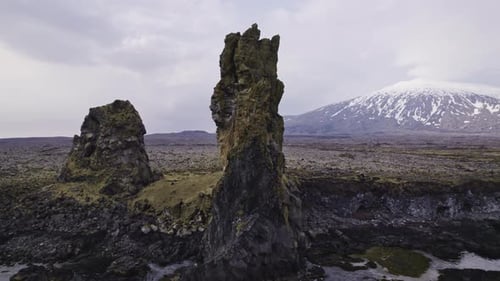 Stone Structures By Sea Waters Vast Open Field With Glimpse of Mountain Ranges