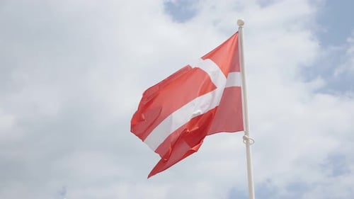 Red national flag of Danemark in front of cloudy sky waving 4K 2160p 30fps UHD footage - Red Danish