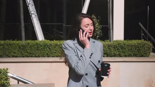 Portrait of Businesswoman Talking Phone at Street