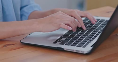 Hands Typing on Silver Laptop Close Up
