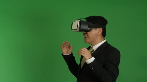 Excited Young Adult Using VR Headset on Green Screen