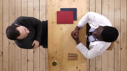 African Doctor Treating Caucasian Patient About His Depresion