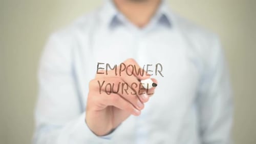 Empower Yourself Phrase Written on Clear Surface