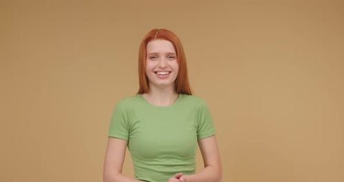 Woman Laughing and Covering Mouth