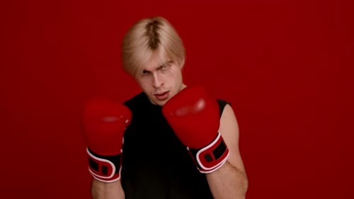 Young Adult Man Poses with Boxing Gloves