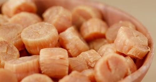 Close Up of Dried Scallops in Wooden Bowl
