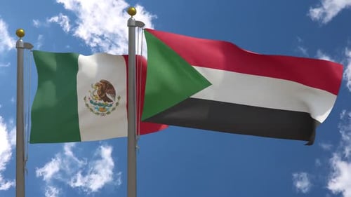 Mexico and Sudan National Flags Waving Against Blue Sky