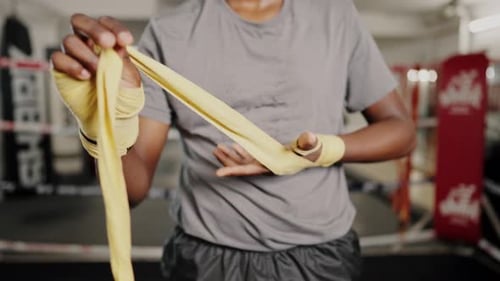 Person Wrapping Hands in Gym Boxing Ring