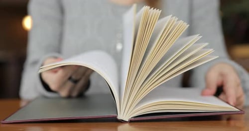 Person Turn Pages in the Book Close Up