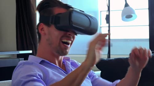 Man Laughing, Enjoying Virtual Reality Headset Experience