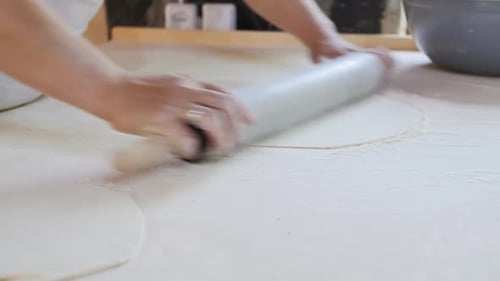 Person Rolling Dough with Rolling Pin