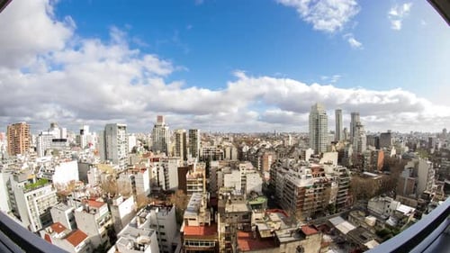 Scenic Cityscape with Dynamic Clouds Above Buildings