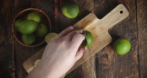 Hands Men Cut the Lime Into Two Halves.