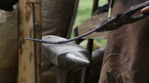 Blacksmith Shaping Metal on Anvil with Hammer