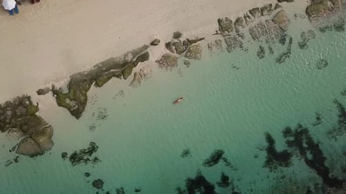 Woman Relaxing in the Sea on a Surfboard
