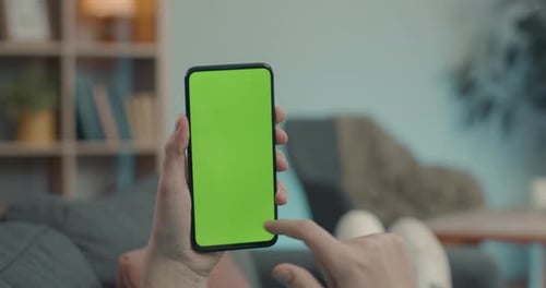 Close Up of Mobile Phone with Green Screen in Male Hands