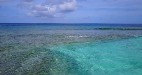 Wide above tourism shot of a sunshine white sandy paradise beach and blue ocean background in colorf