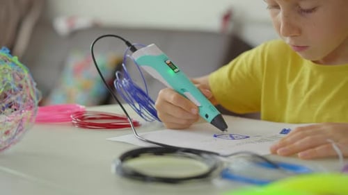Close Up Shot of a Little Boy That Is Using a 3d Pen