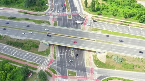 Aerial view of a freeway intersection. Clip. Highway and overpass with cars and trucks, interchange,