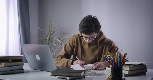 Calm Caucasian Boy Making Mistake in Notes and Throwing Teared Off Page To Camera. College Student