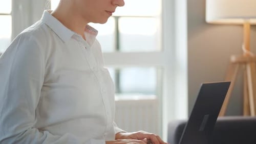 Woman Typing on Laptop at Home Indoors