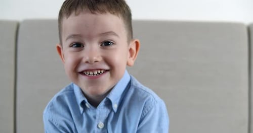 Smiling Boy in Blue Shirt Close Up Portrait