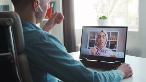 Young male entrepreneur works at home office at the computer.