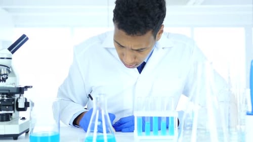 Scientist Analyzing Sample with Microscope in Modern Laboratory