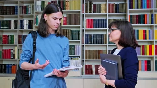 Talking Female Teacher and Guy College Student in the Library Room