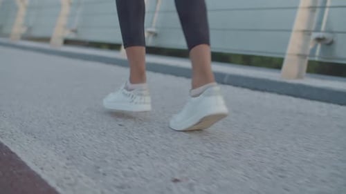 Legs Walking on Urban Pedestrian Bridge Path