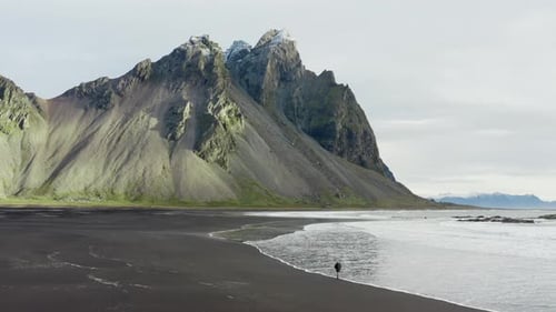Drone Of Man On Black Beach Under Vestrahorn Mountain