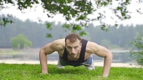Man Does Pushups Outdoors by Lake