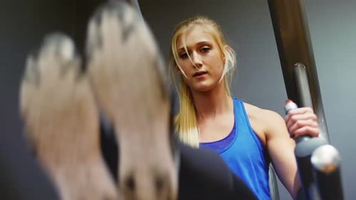 Blonde Woman Working Out at the Gym on Machine