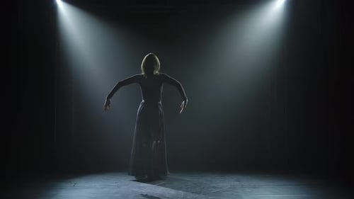 Young and Energetic Woman Dances Contempt. A Silhouette of a Slender Dancer Who Gracefully Moves in