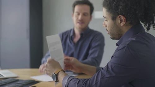 Business colleagues reading document