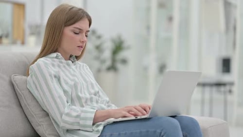 Woman Experiencing Back Pain While Using Laptop