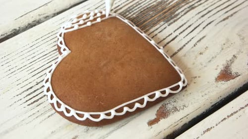 Decorating Gingerbread Heart Cookie with White Icing