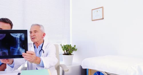 Doctors Reviewing X-Ray Image in Office