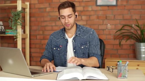 Portrait of Young Man College Student on Distant Learning Chatting with Teacher on Laptop Sitting at